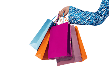 Hand holding colorful shopping bags. Retail therapy concept.