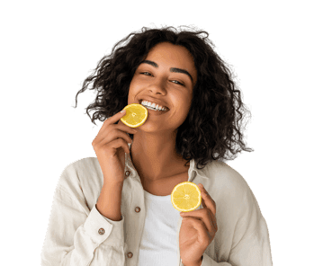 Smiling woman holding fresh lemon halves, promoting healthy lifestyle.