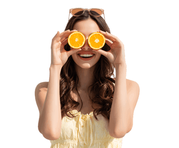 Playful woman with orange slices, enjoying summer vibes.