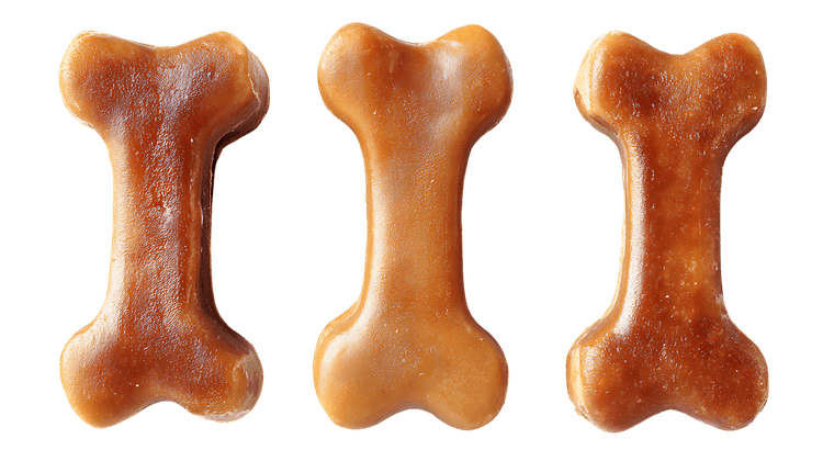 Three dog bones isolated on black background.