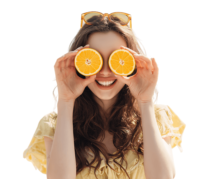Young woman having fun with orange slices, enjoying summer vibes.