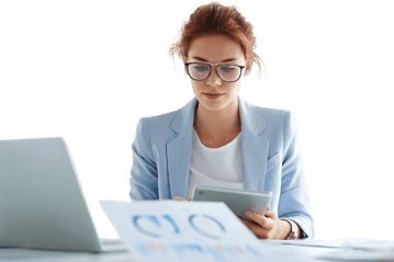 Businesswoman analyzing data on tablet with laptop, showcasing productivity and technology in business.