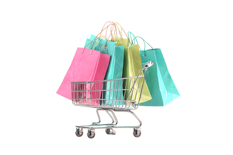 Shopping cart overflowing with colorful shopping bags.