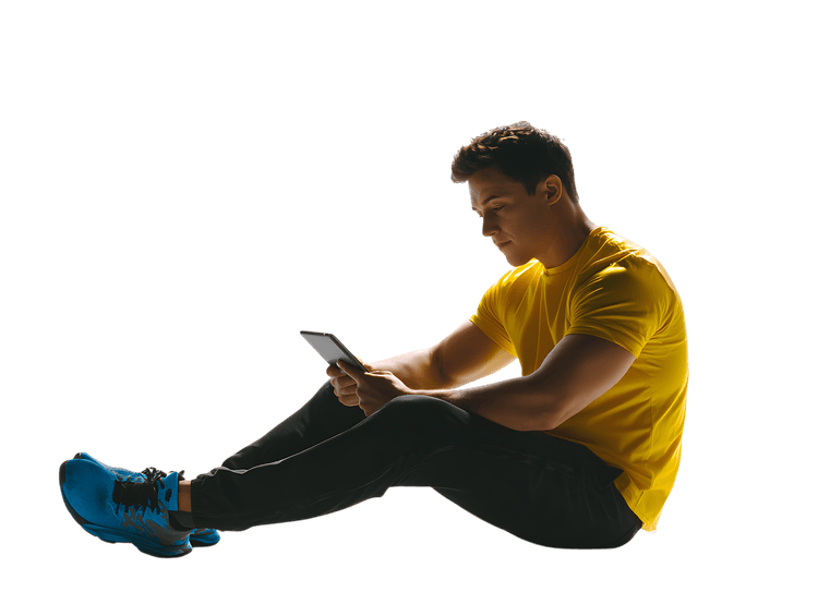 Muscular athlete rests, using tablet post workout.